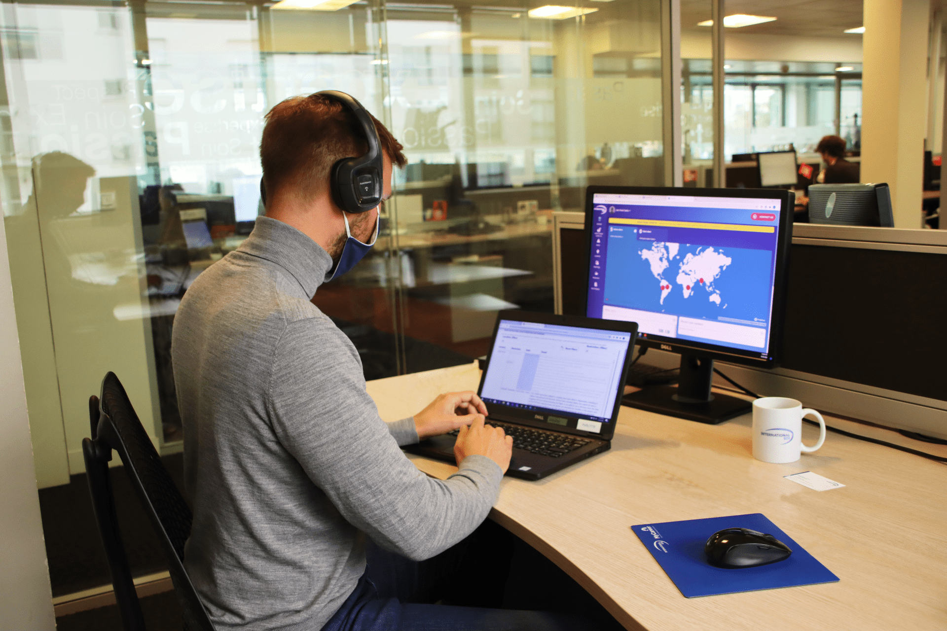 france-paris-office-security-meeting-male-employee-working-at-desk-wearing-branded-mask